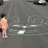 Three-year-old Elizabeth admires the artwork she and her brothers created on Lemoore's Freedom Drive Saturday afternoon (April 11).